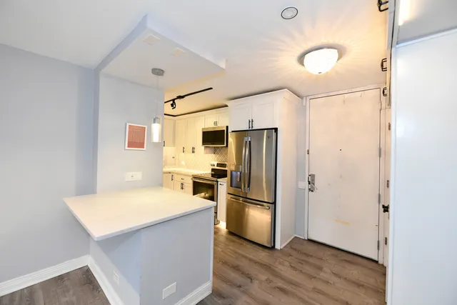 a kitchen with a refrigerator and a stove