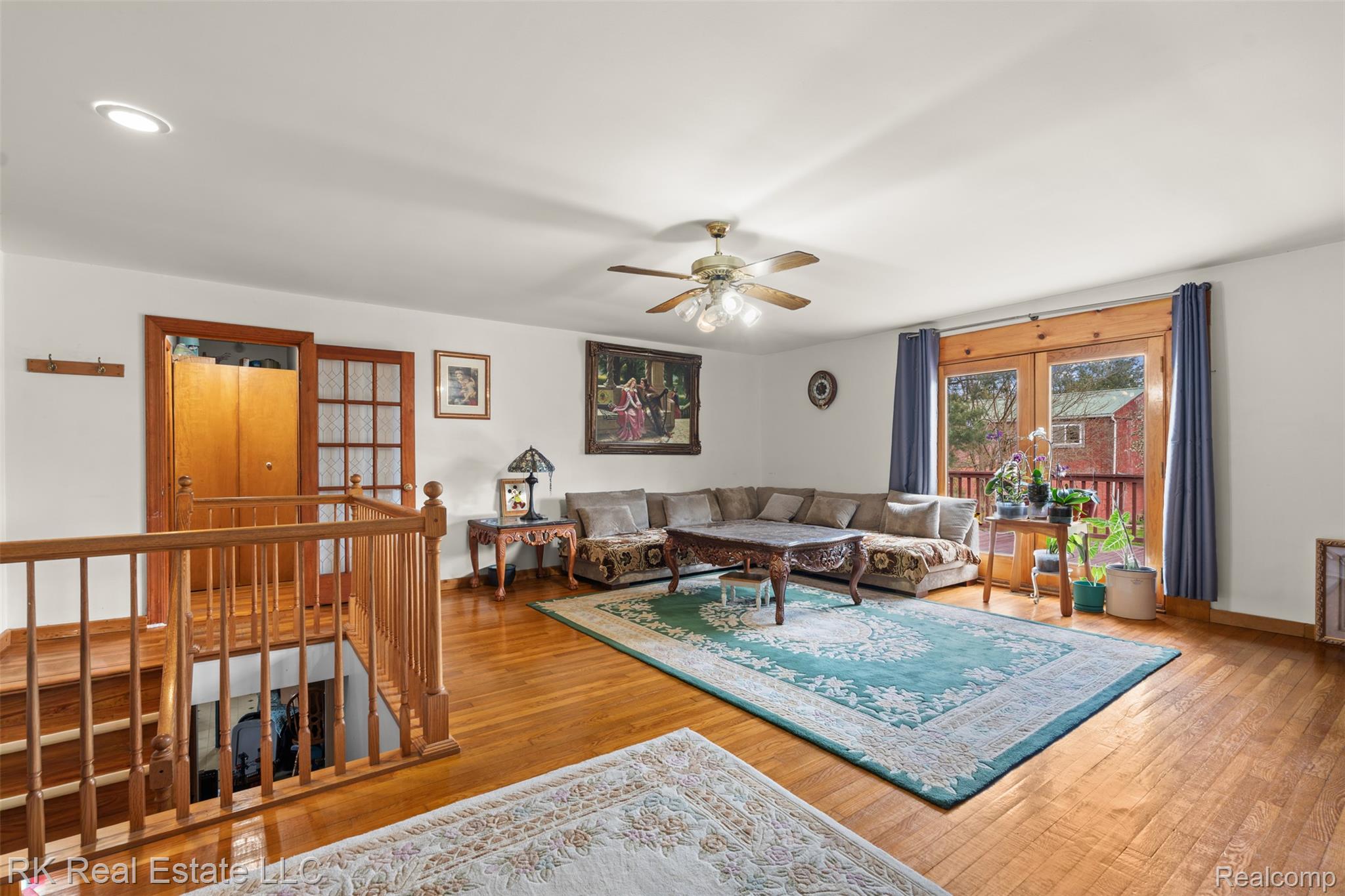 13799 31 Mile Road Washington, MI 48095 - Photo 18 of 40 Living room with a ceiling fan and wood-type flooring