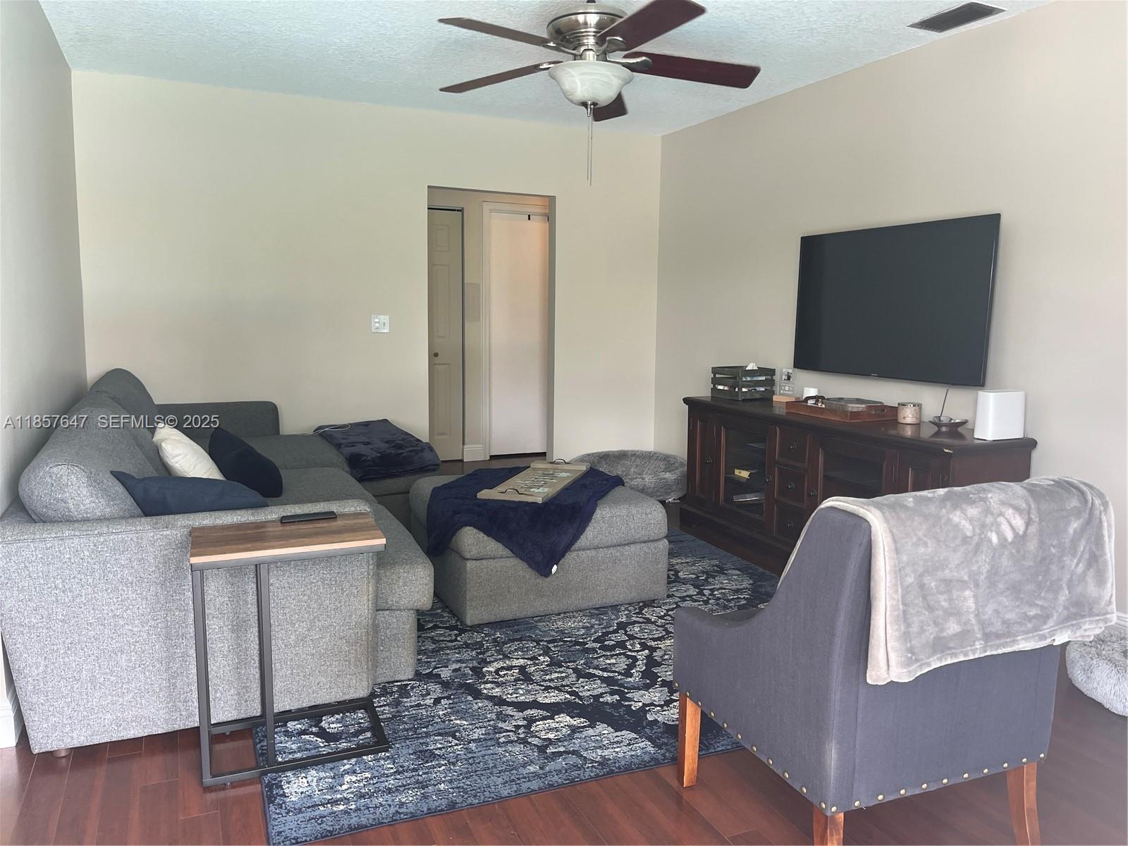 5217 Southwest 87th Avenue Cooper City, FL 33328 - Photo 7 of 8 a living room with furniture and a flat screen tv