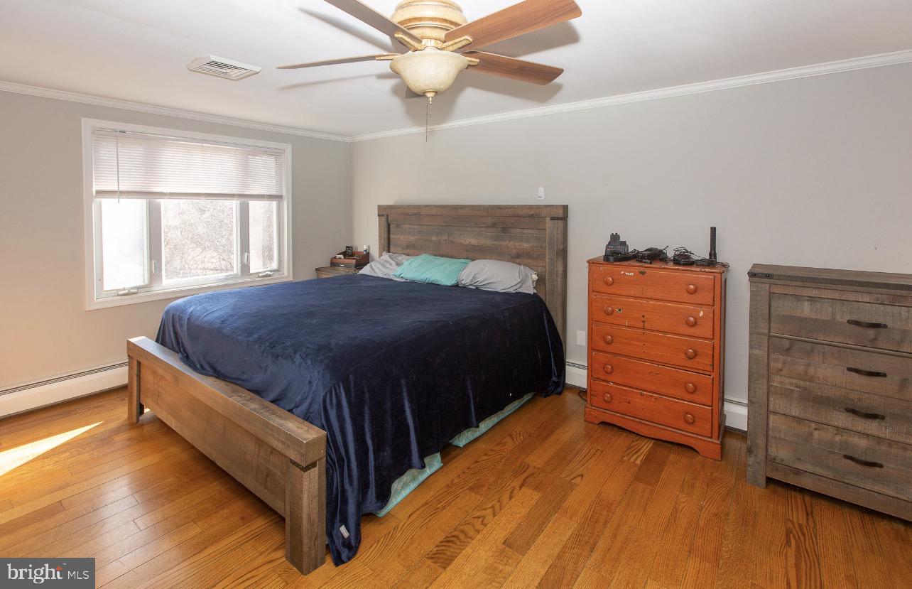 2947 Potshop Road Norristown, PA 19403 - Photo 17 of 41 a bedroom with a bed and a dresser