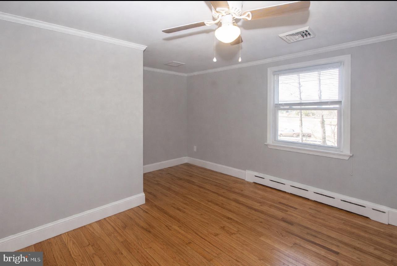 2947 Potshop Road Norristown, PA 19403 - Photo 27 of 41 an empty room with wooden floor chandelier fan and windows