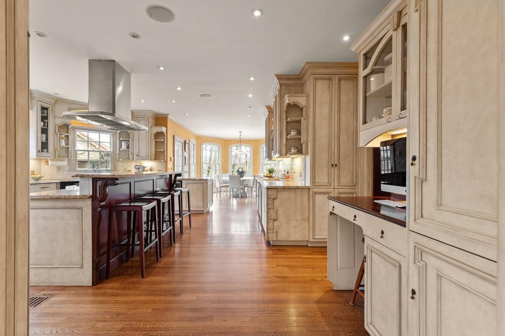 32 Everett Avenue Winchester, MA 01890 - Photo 16 of 42 a kitchen with stainless steel appliances granite countertop a refrigerator and a stove top oven