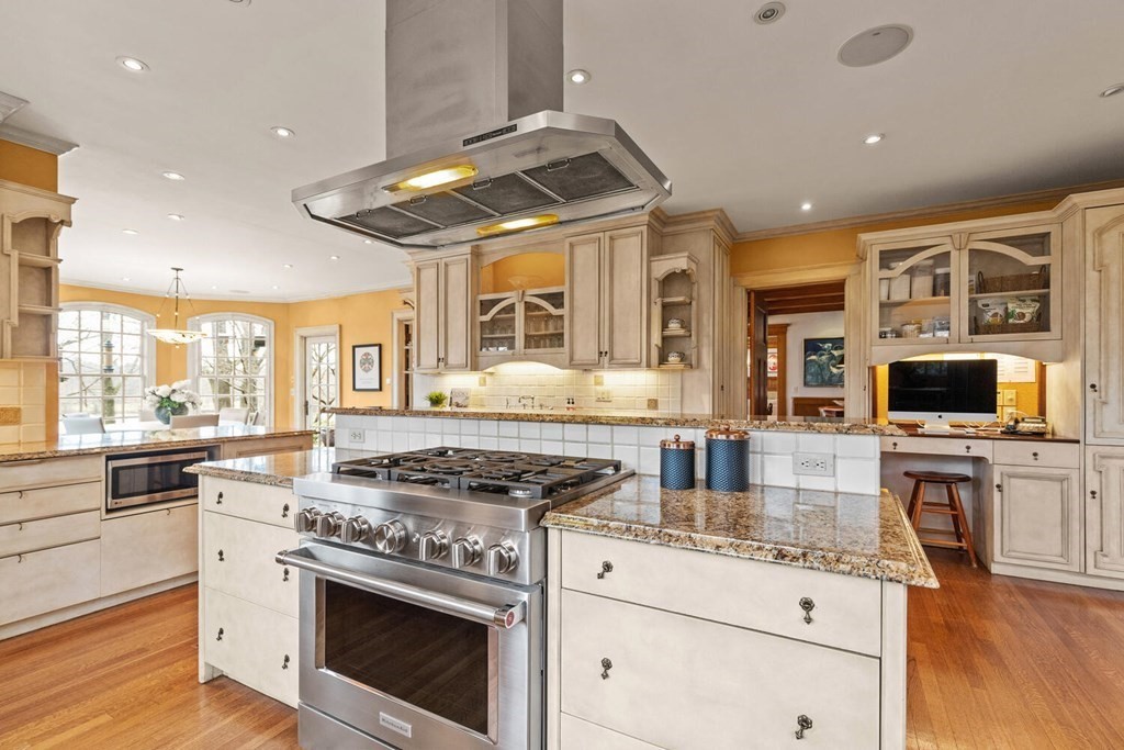 32 Everett Avenue Winchester, MA 01890 - Photo 18 of 42 a kitchen with stainless steel appliances granite countertop a stove and a sink