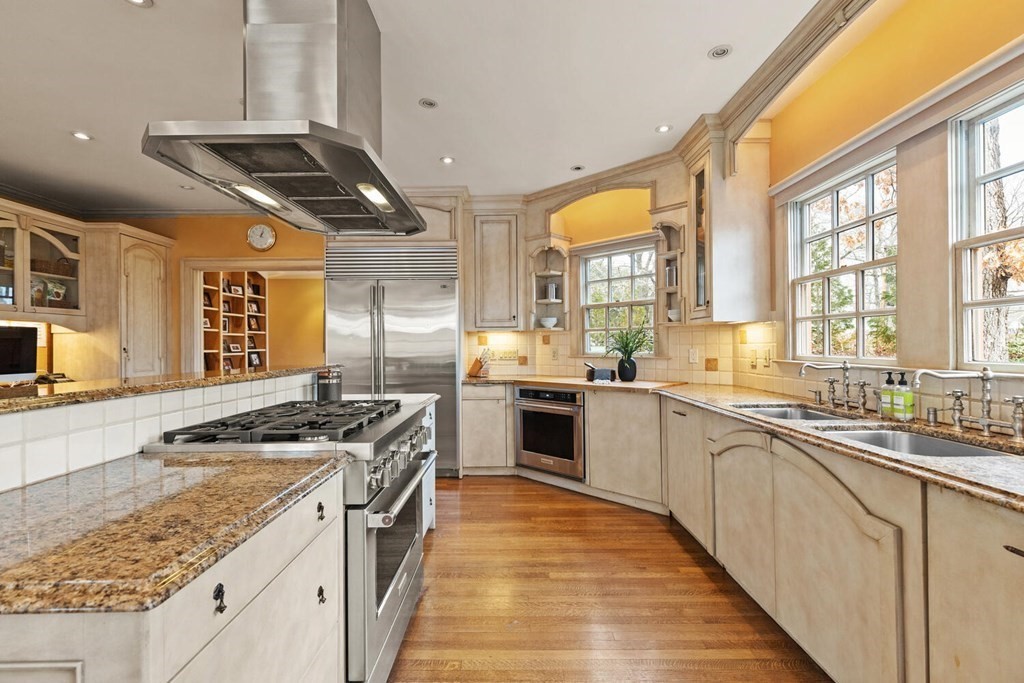 32 Everett Avenue Winchester, MA 01890 - Photo 19 of 42 a kitchen with stainless steel appliances granite countertop a stove and a sink