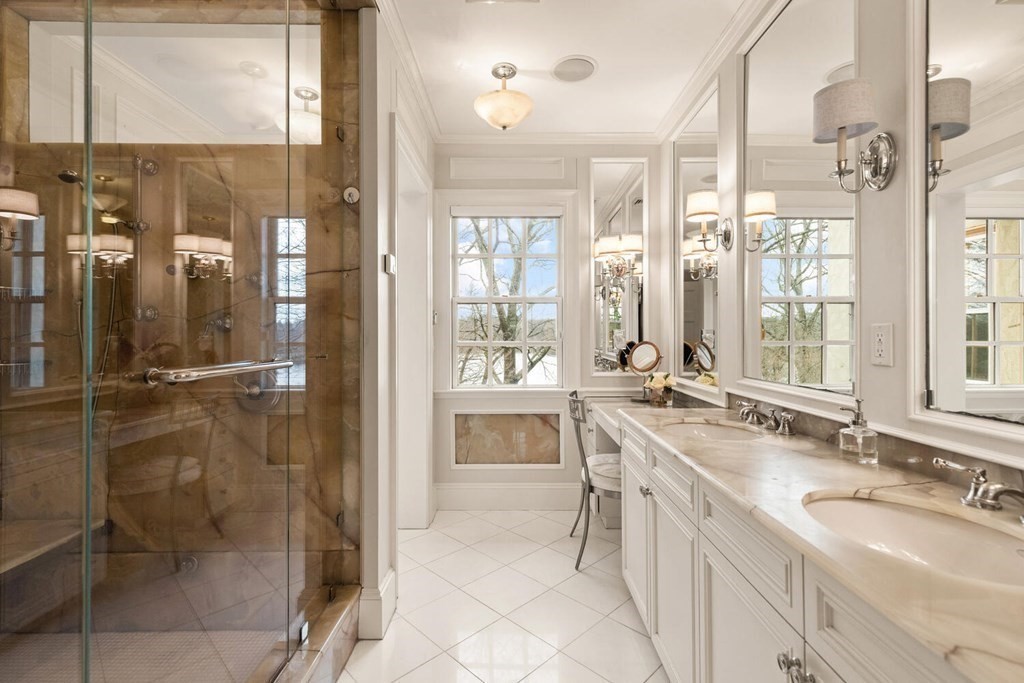 32 Everett Avenue Winchester, MA 01890 - Photo 25 of 42 a bathroom with a double vanity sink a mirror and a shower