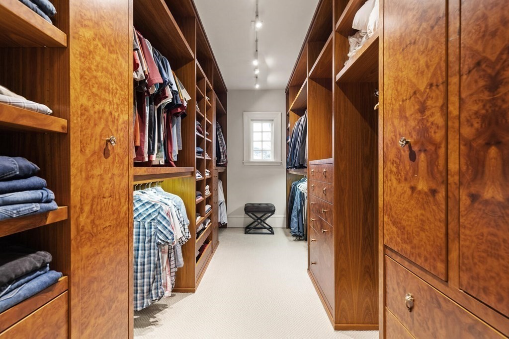 32 Everett Avenue Winchester, MA 01890 - Photo 26 of 42 a view of walk in closet with clothes and shoes