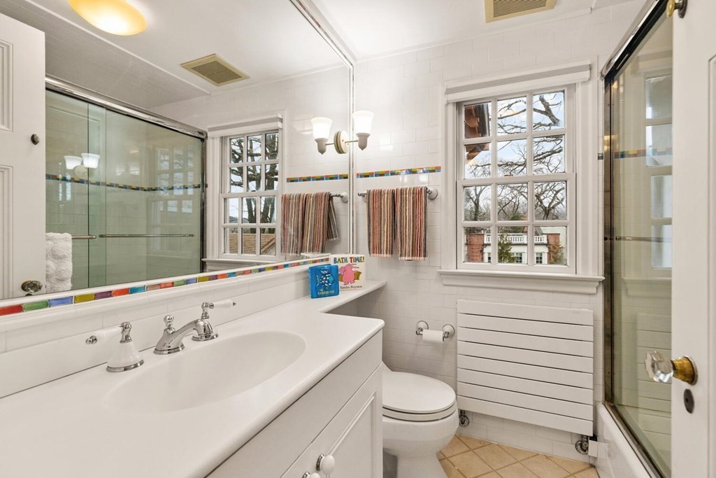 32 Everett Avenue Winchester, MA 01890 - Photo 28 of 42 a bathroom with a sink a toilet and shower