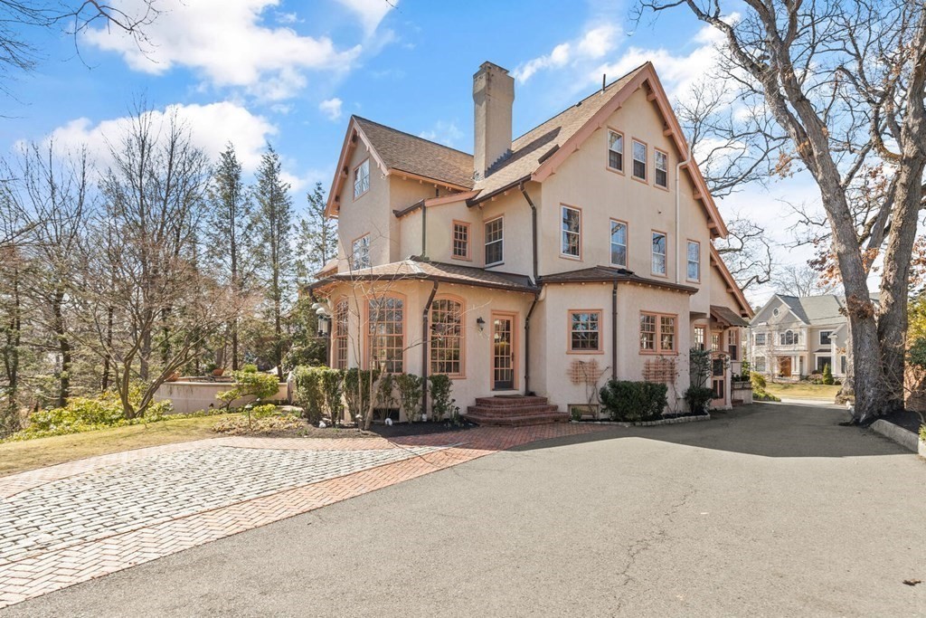 32 Everett Avenue Winchester, MA 01890 - Photo 33 of 42 a view of a white house with a large windows