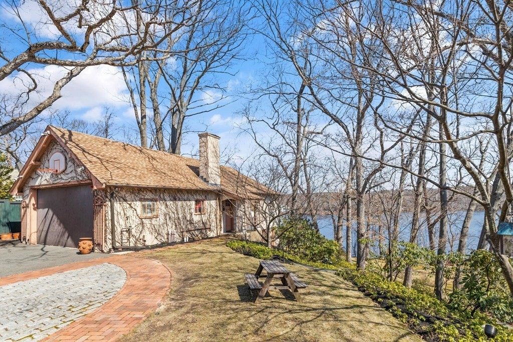 32 Everett Avenue Winchester, MA 01890 - Photo 36 of 42 a view of a house with a yard covered with snow in the outdoor