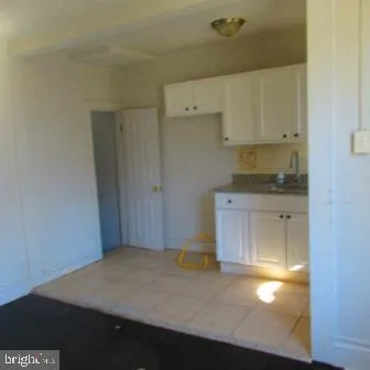 a kitchen with white cabinets and a stove