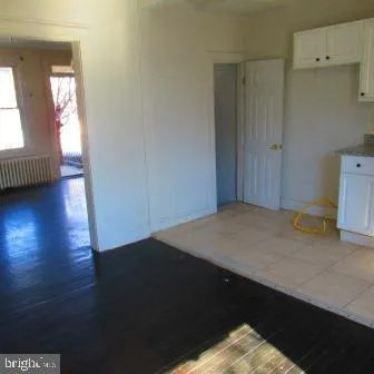 a view of a bedroom with wooden floor