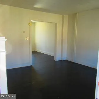 an empty room with wooden floor