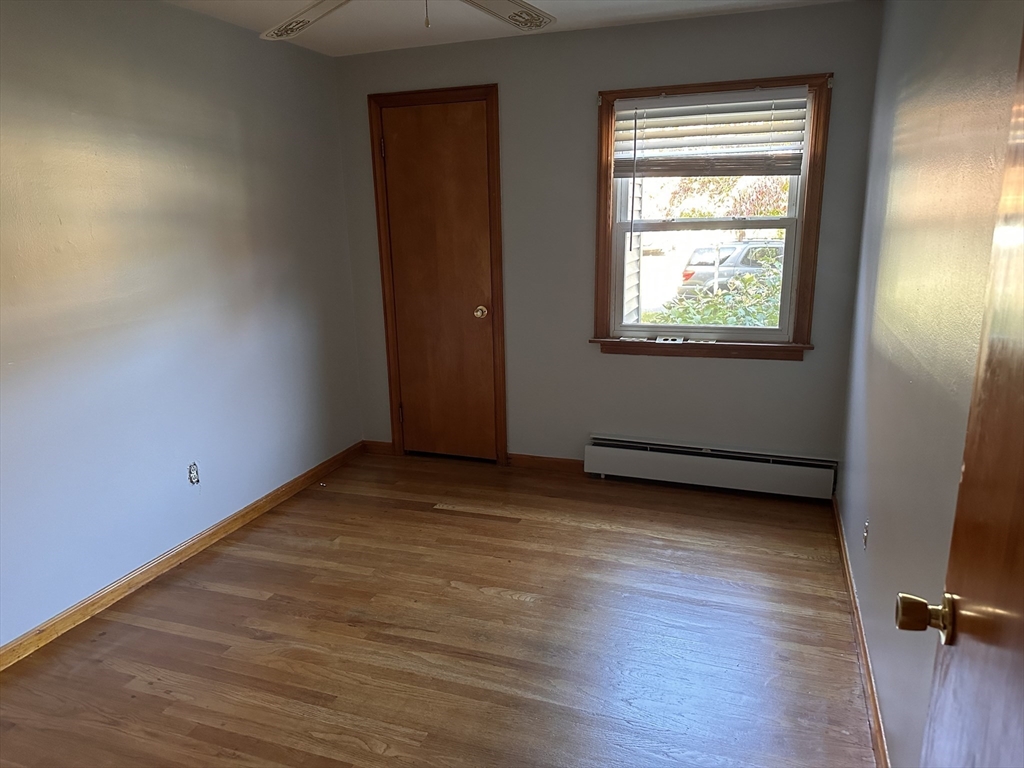37 Bretton Road Springfield, MA 01119 - Photo 11 of 36 an empty room with wooden floor and windows