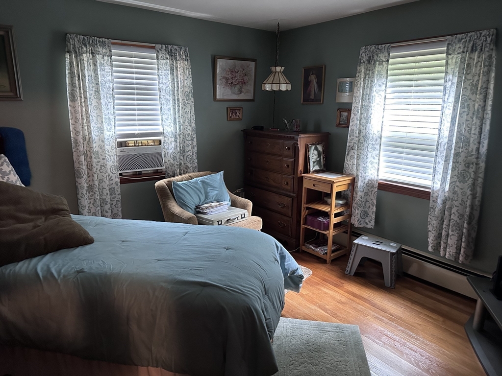 37 Bretton Road Springfield, MA 01119 - Photo 12 of 36 a bedroom with a bed and wooden floor