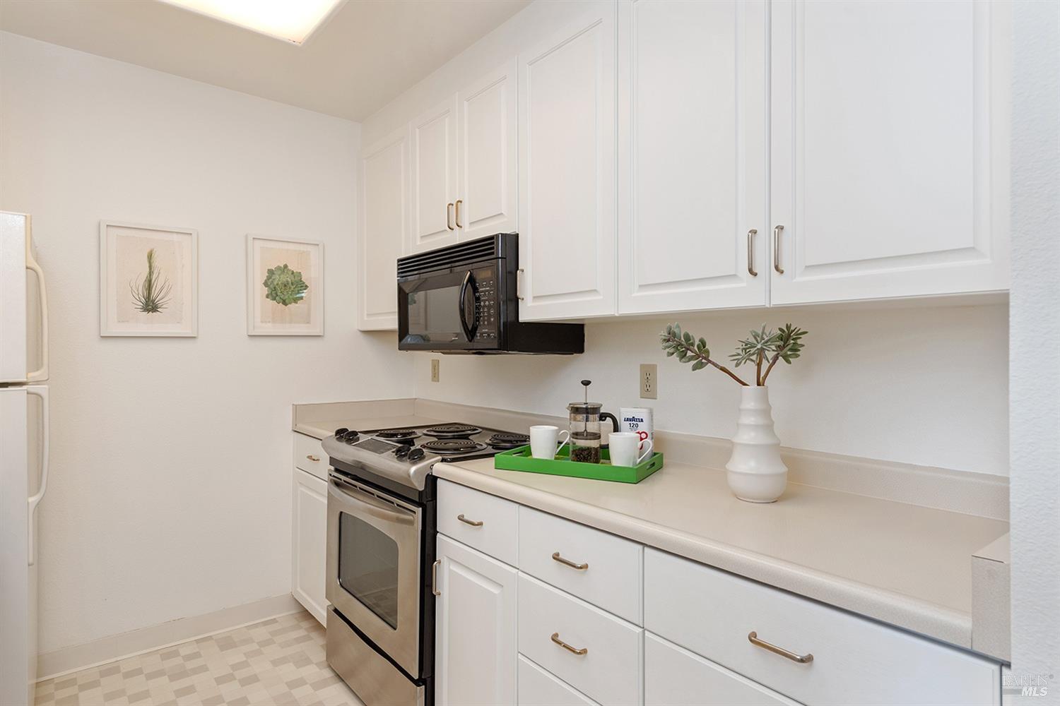100 Thorndale Drive, Unit 149 San Rafael, CA 94903 - Photo 11 of 38 a kitchen with white cabinets and appliances