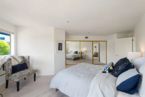 a bedroom with a bed couch and window