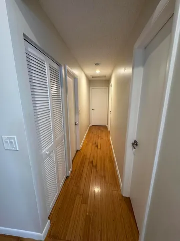 a view of a hallway with wooden floor