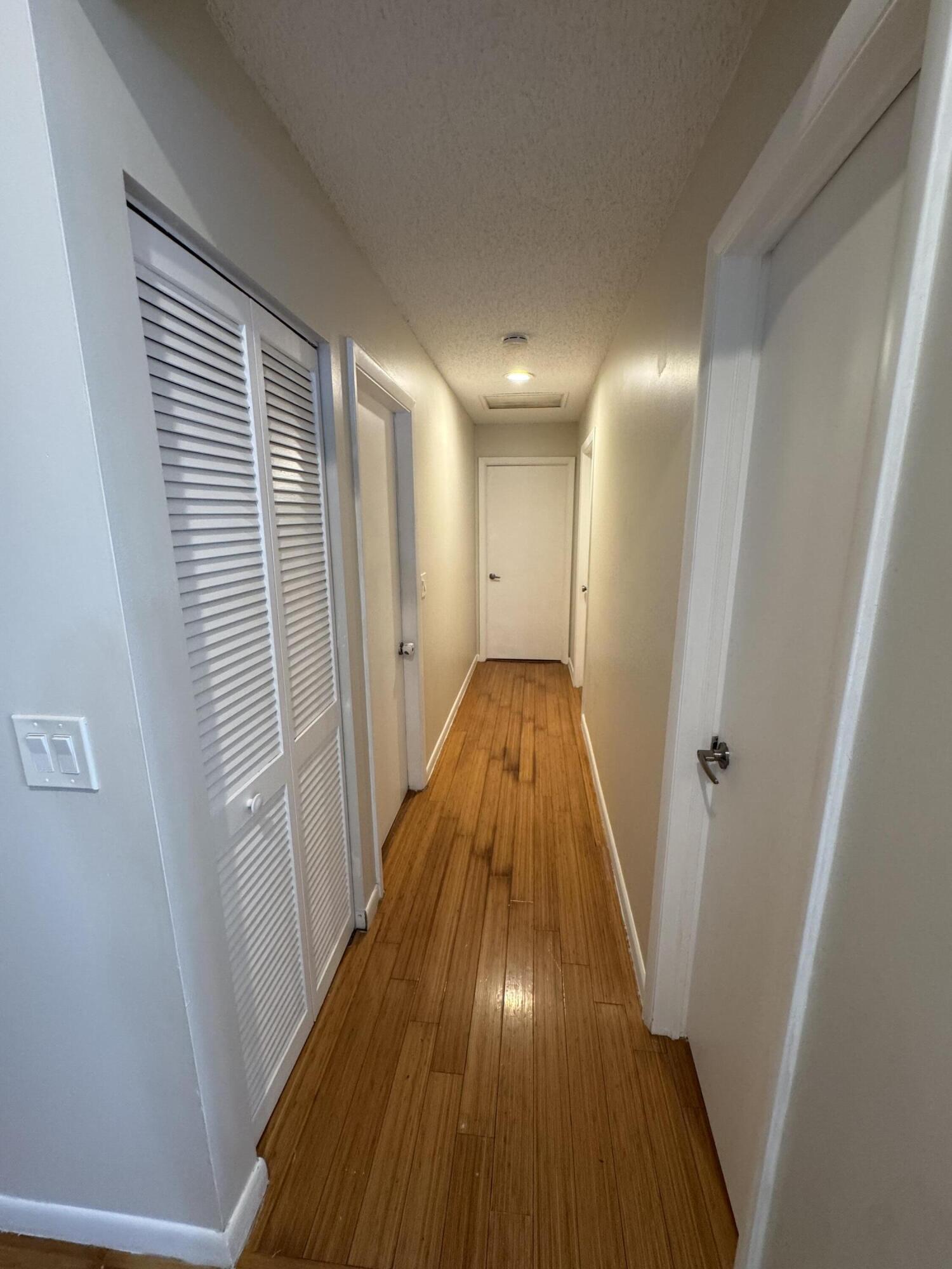 9777 Nickels Boulevard, Unit 705 Boynton Beach, FL 33436 - Photo 16 of 41 a view of a hallway with wooden floor