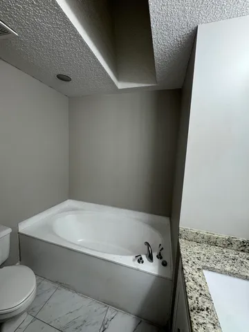 a bathroom with a bathtub and toilet