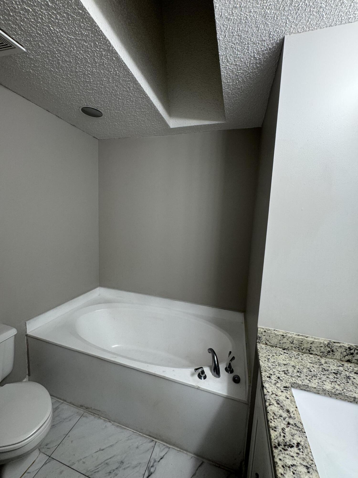 9777 Nickels Boulevard, Unit 705 Boynton Beach, FL 33436 - Photo 27 of 41 a bathroom with a bathtub and toilet