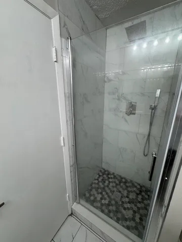 a bathroom with a glass door shower