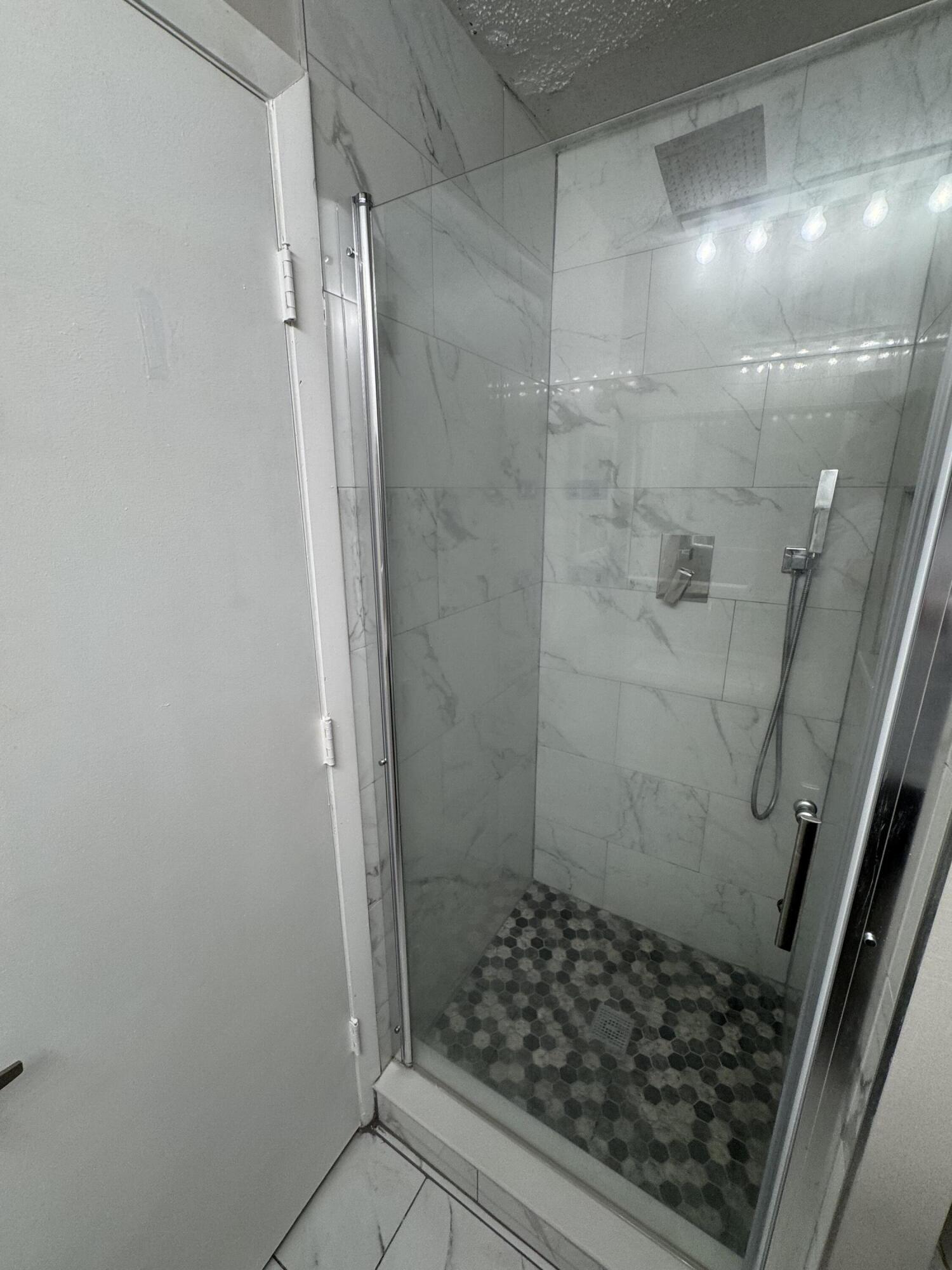 9777 Nickels Boulevard, Unit 705 Boynton Beach, FL 33436 - Photo 28 of 41 a bathroom with a glass door shower