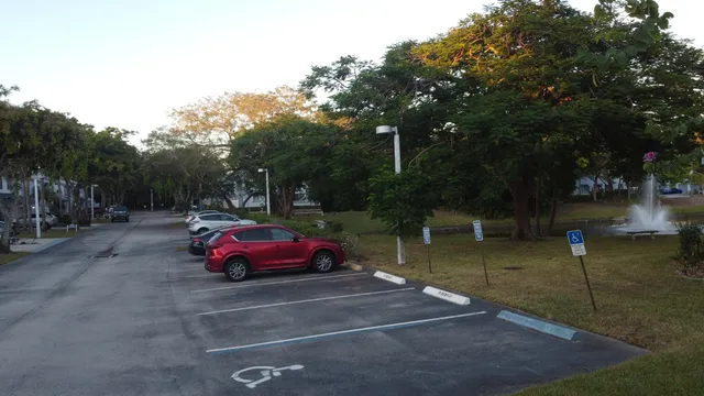 a view of a yard with red chairs