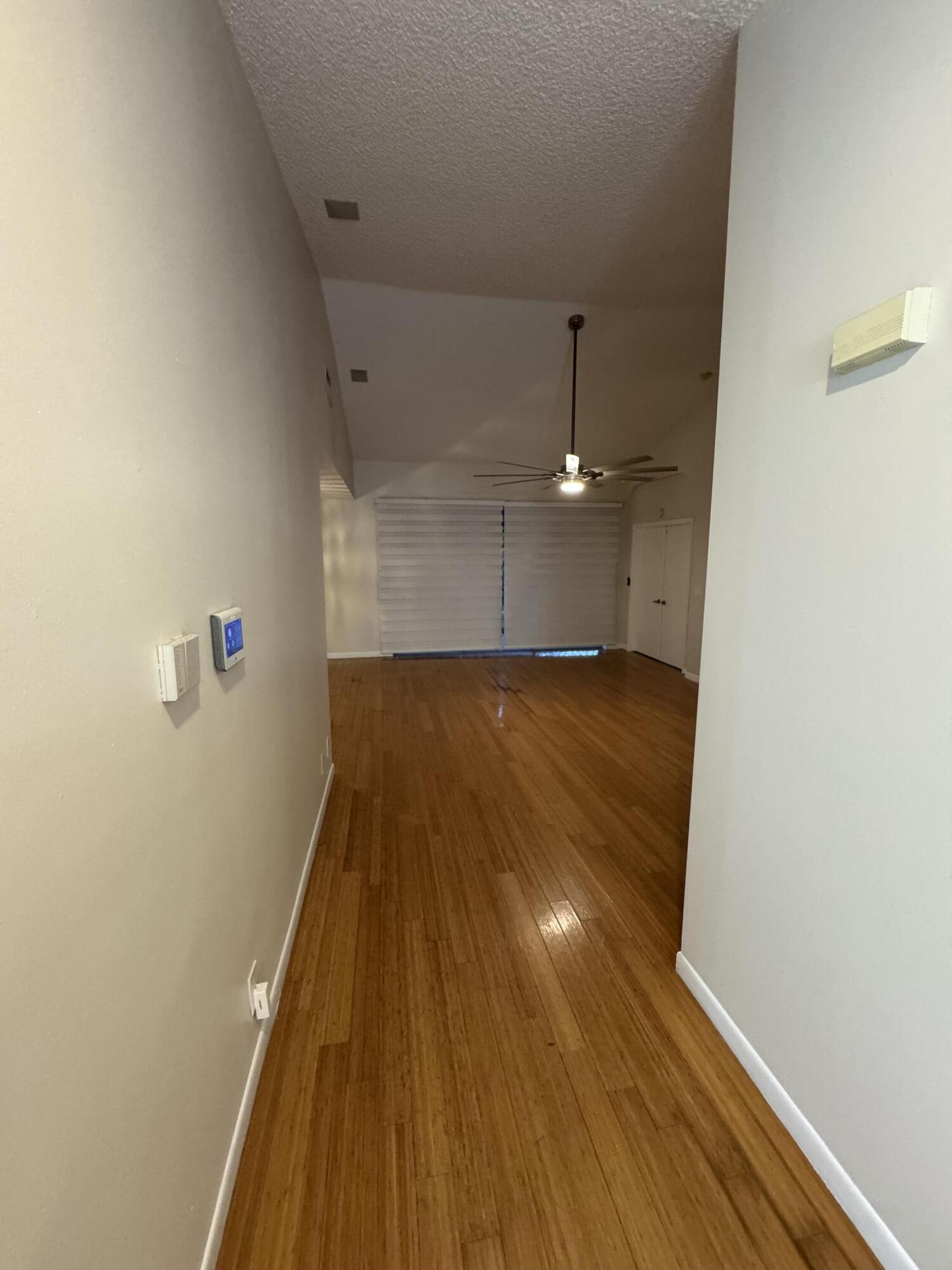 9777 Nickels Boulevard, Unit 705 Boynton Beach, FL 33436 - Photo 5 of 41 an empty room with wooden floor and fan