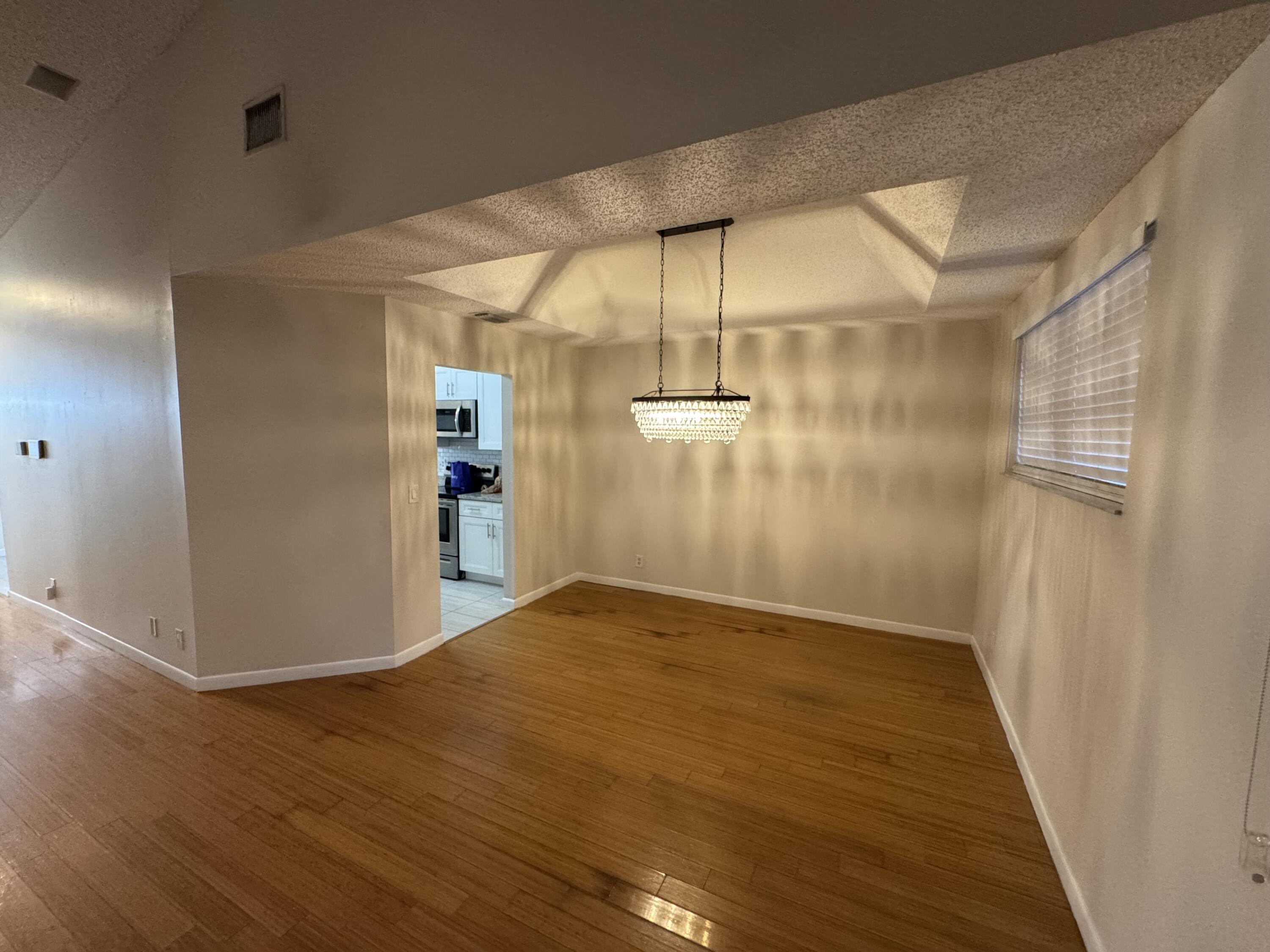 9777 Nickels Boulevard, Unit 705 Boynton Beach, FL 33436 - Photo 6 of 41 a view of empty room with wooden floor