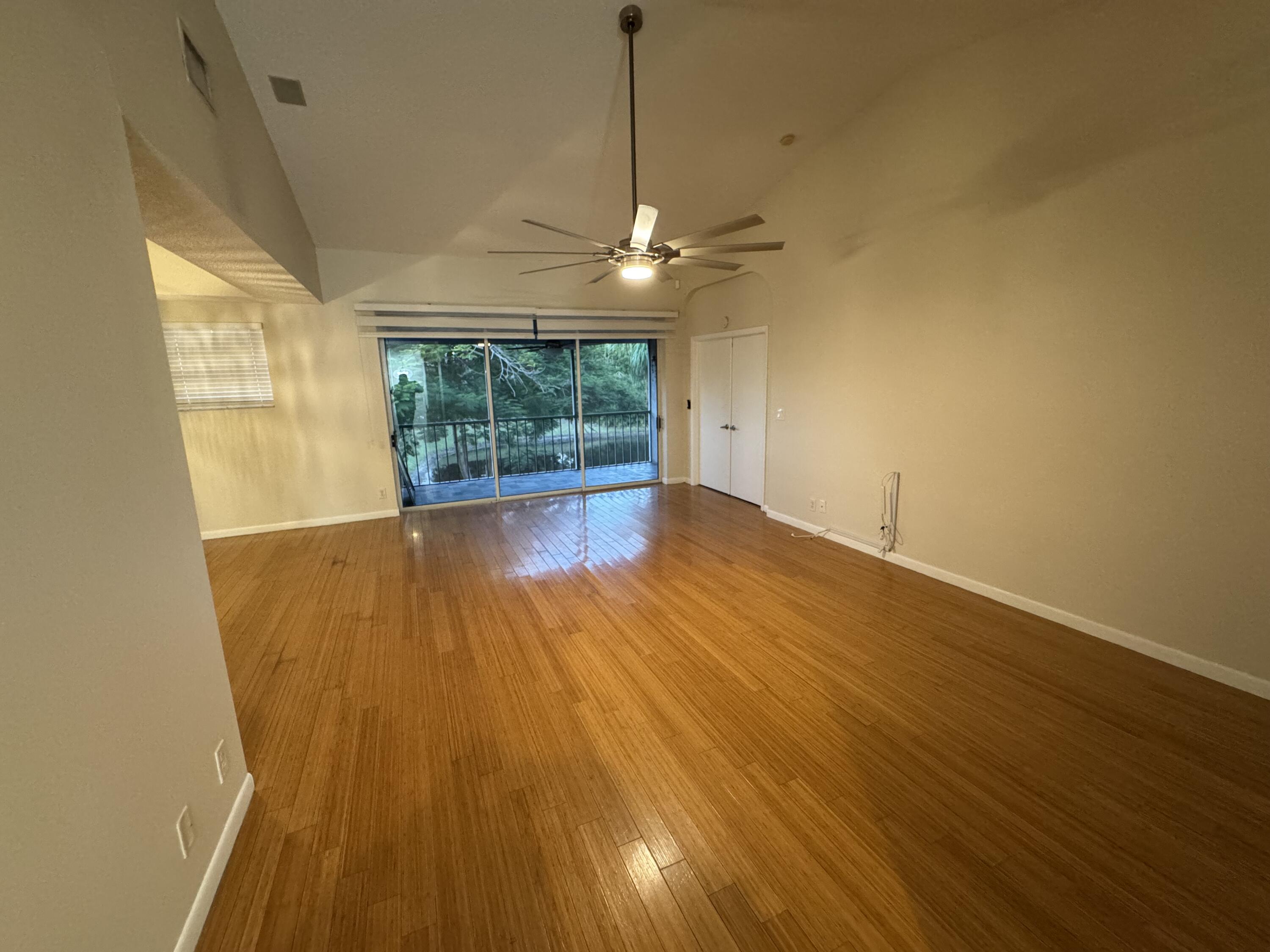 9777 Nickels Boulevard, Unit 705 Boynton Beach, FL 33436 - Photo 8 of 41 a view of empty room with wooden floor and fan