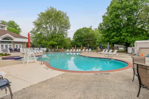 an outdoor space with swimming pool and furniture