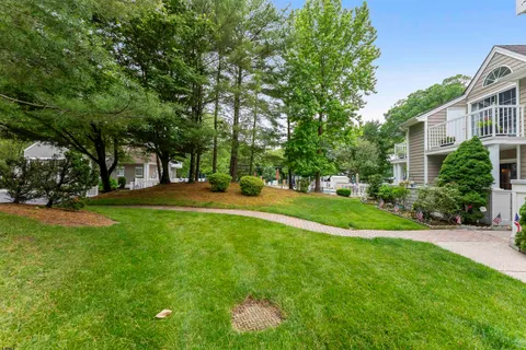 a view of street with houses and trees in the background