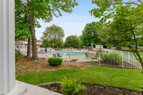 a view of a porch with furniture and floor to ceiling window