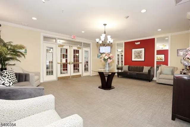 a living room with furniture and a chandelier