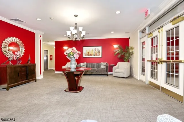 a living room with furniture a chandelier and a flat screen tv