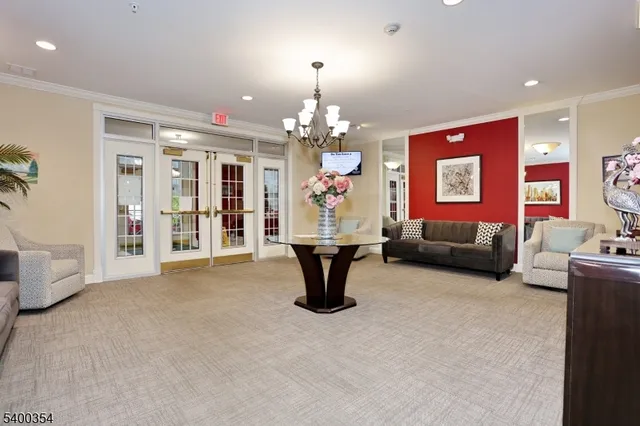 a living room with furniture a chandelier and a fireplace