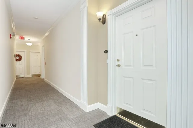 a kitchen with stainless steel appliances granite countertop a table chairs refrigerator and sink