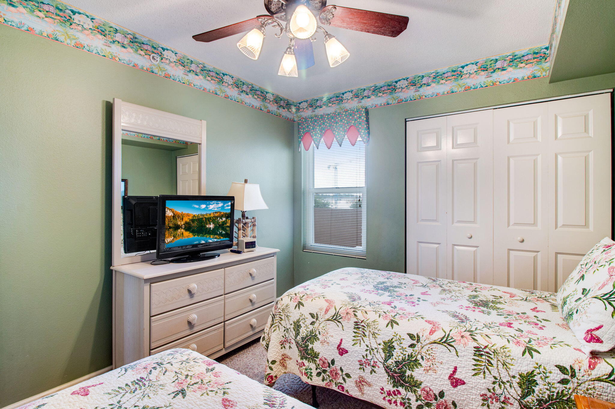 970 Highway 98, Unit 303 Destin, FL 32541 - Photo 31 of 42 a bedroom with a bed and a flat screen tv in it