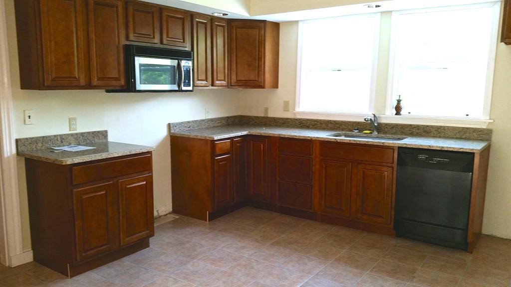 551 Brimfield Road Warren, MA 01083 - Photo 3 of 6 a kitchen with granite countertop a sink stove and microwave