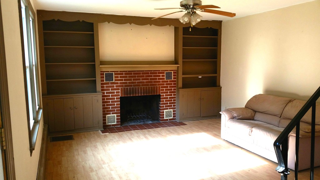 551 Brimfield Road Warren, MA 01083 - Photo 4 of 6 a living room with a fireplace and a walk in closet