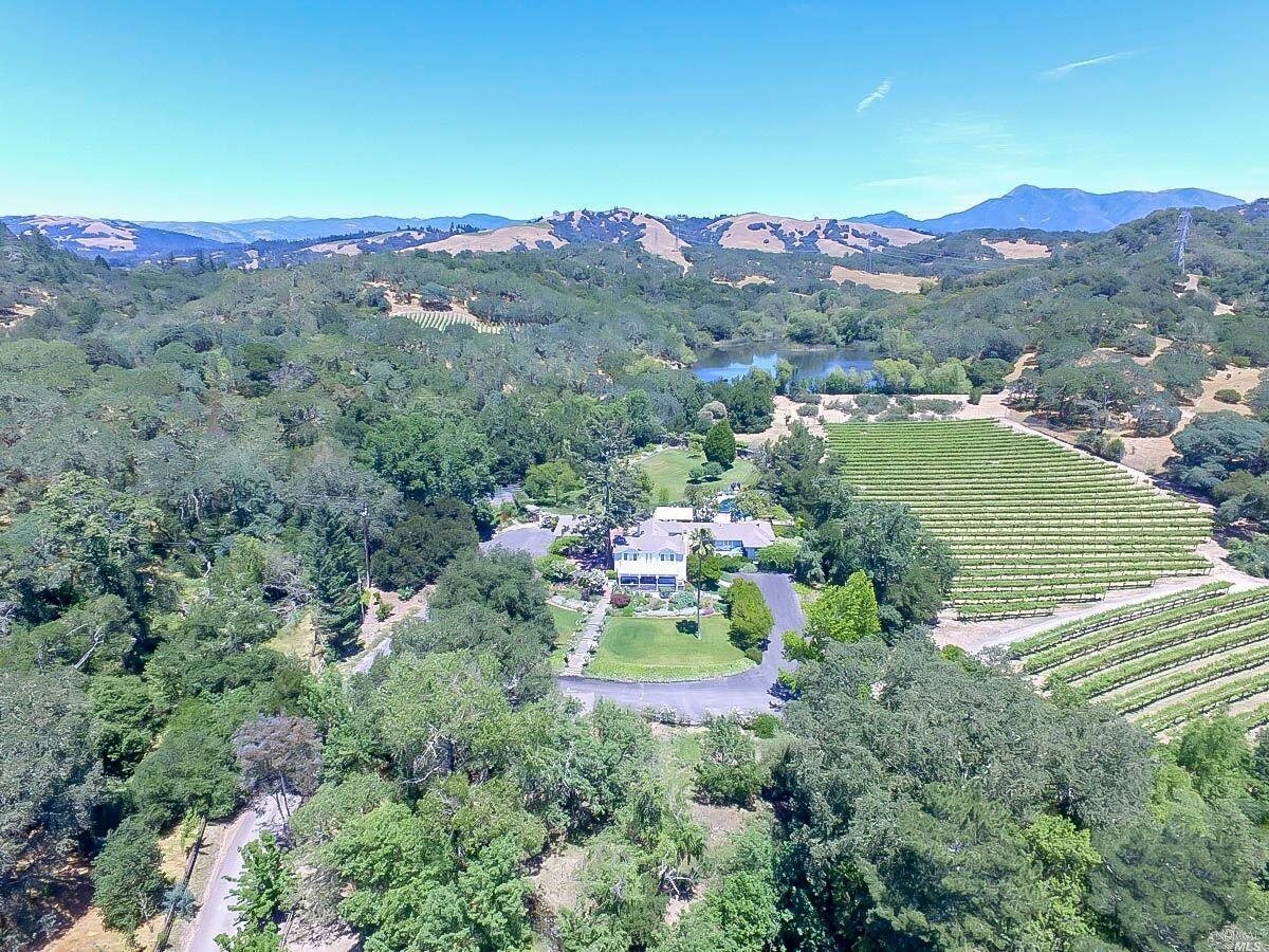 an aerial view of a town with residential houses and mountain view