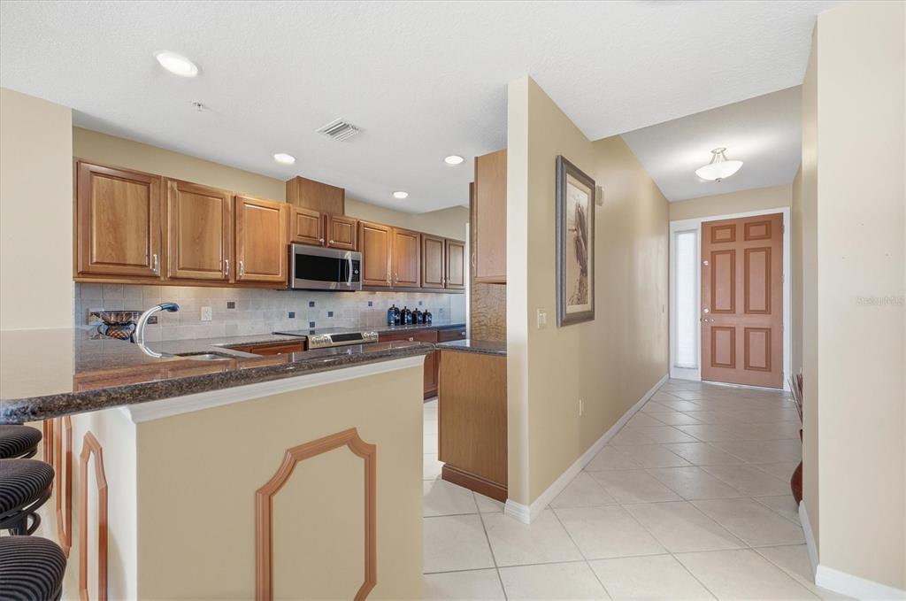 13113 Gasparilla Road, Unit 403 Placida, FL 33946 - Photo 13 of 62 a kitchen with stainless steel appliances granite countertop a refrigerator sink and cabinets