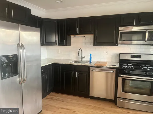 a kitchen with a sink stove and microwave