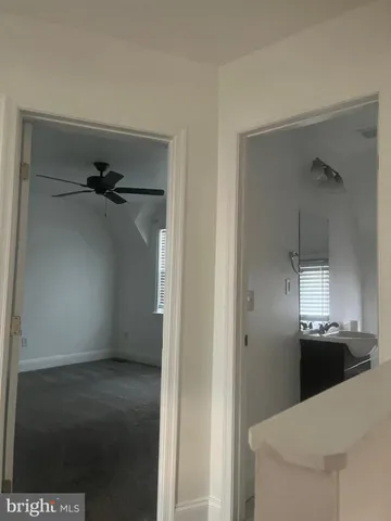 a view of a kitchen from a hallway