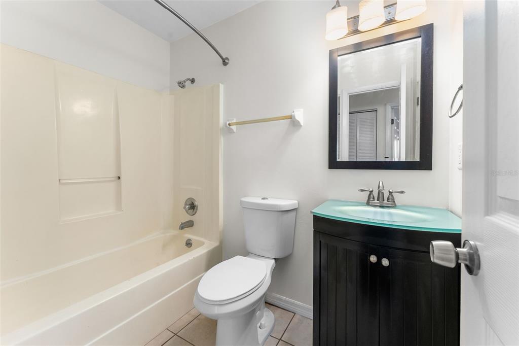 2026 Southwest 73rd Street Gainesville, FL 32607 - Photo 14 of 20 a bathroom with a sink a toilet and shower