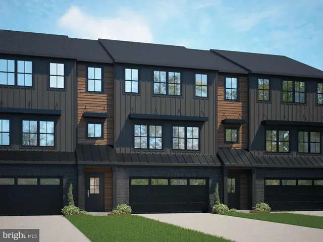 a front view of a building with a garden