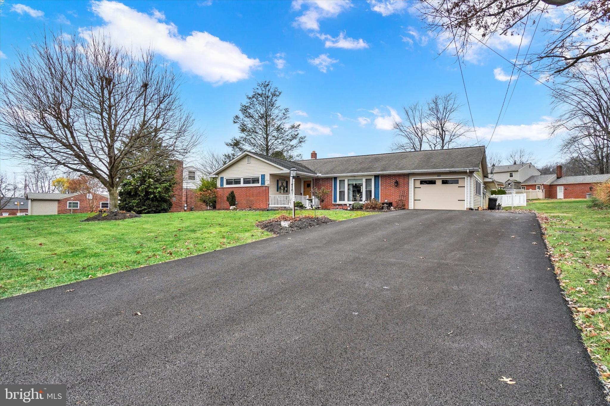 111 Dixie Drive Red Lion, PA 17356 - Photo 2 of 28 a front view of a house with a yard and potted plants