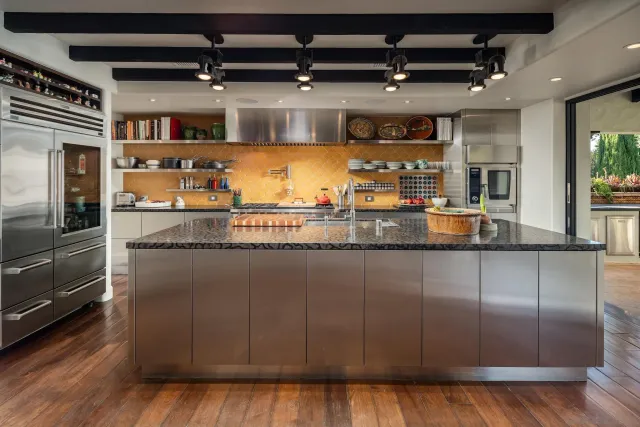 a kitchen with granite countertop a refrigerator and a stove