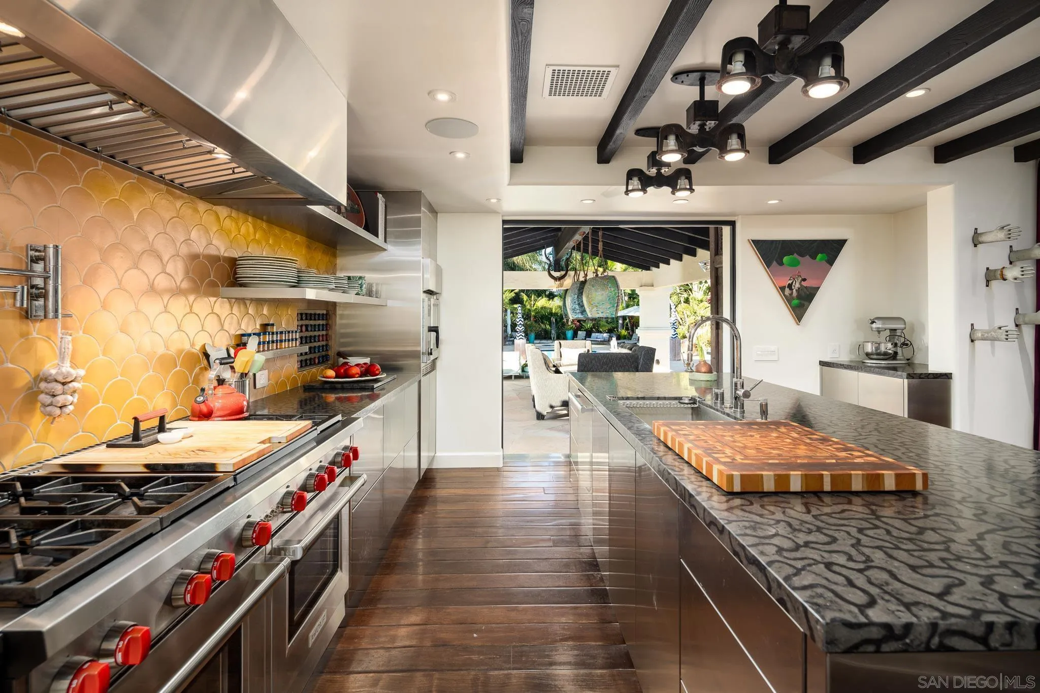 18245 Paseo Victoria Rancho Santa Fe, CA 92067 - Photo 18 of 50 a large kitchen with stainless steel appliances granite countertop a large stove a sink dishwasher and cabinets with wooden floor