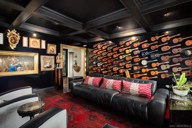 a living room with furniture a flat screen tv and a floor to ceiling window